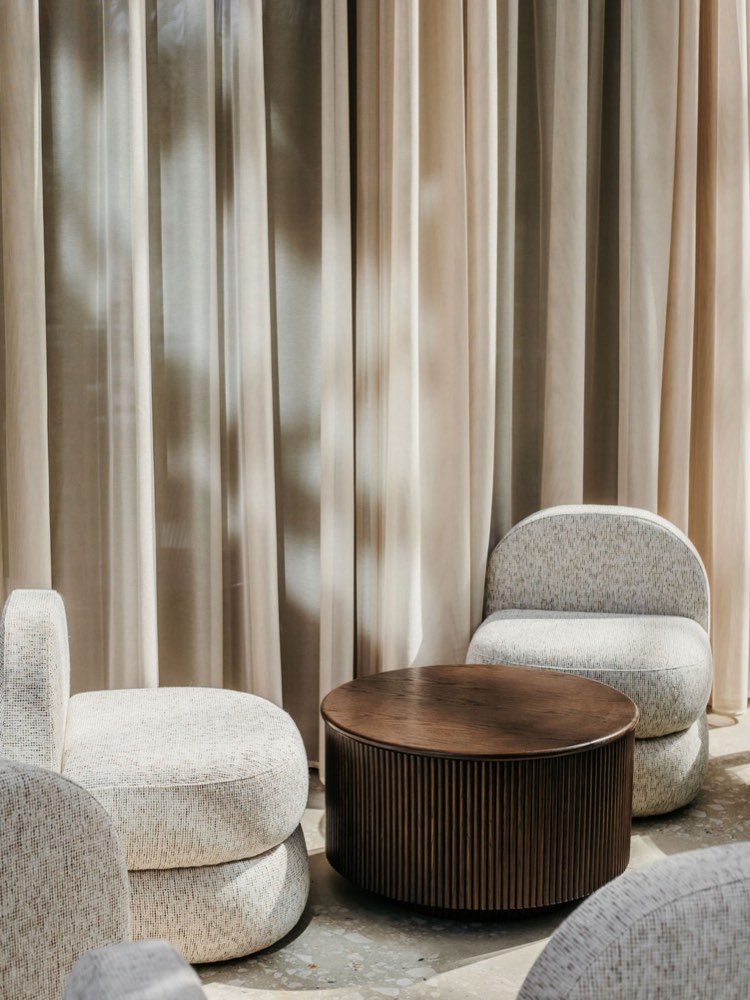 Höfðatorg — bouclé chairs around a fluted drum table, drawn and specified to be built.